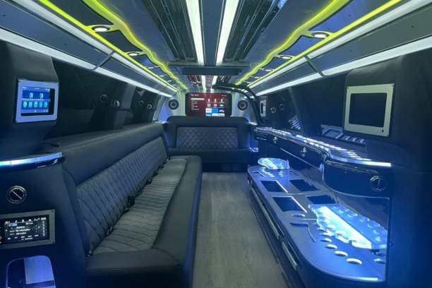 Interior of a luxurious limousine with leather seats and amenities